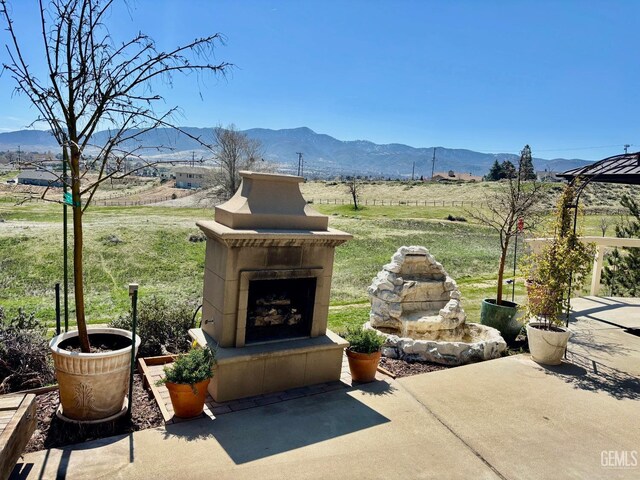 22824 Mariposa Rd, Tehachapi, CA 93561 - view of patio / terrace with a mountain view, a rural view, and an outdoor fireplace