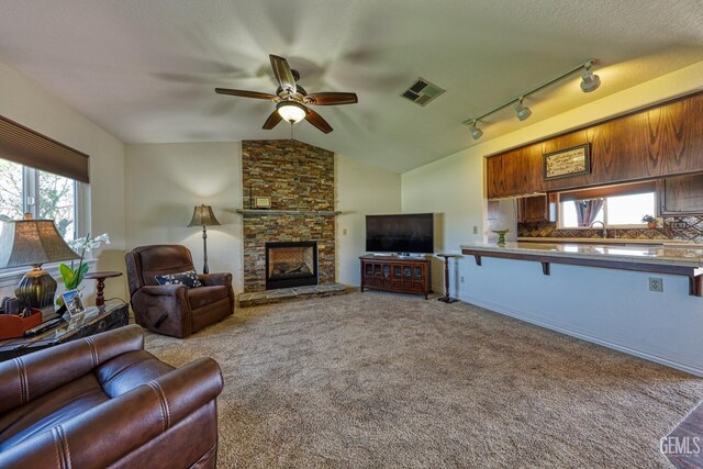22824 Mariposa Rd, Tehachapi, CA 93561 - living room with carpet flooring, visible vents, a fireplace, a ceiling fan, and vaulted ceiling
