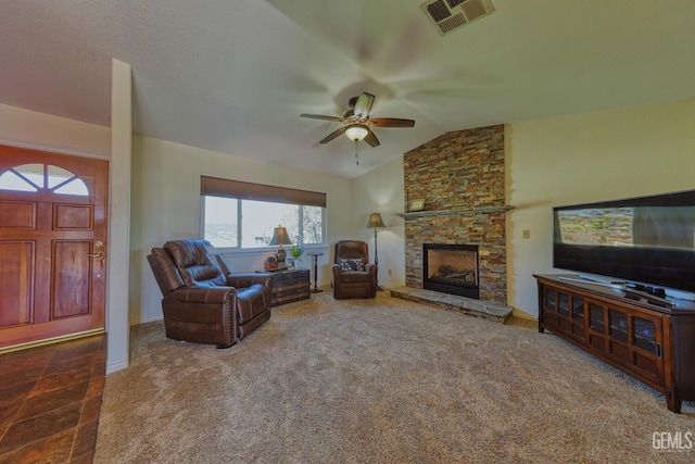 22824 Mariposa Rd, Tehachapi, CA 93561 - living area with vaulted ceiling, carpet floors, a ceiling fan, a stone fireplace, and visible vents