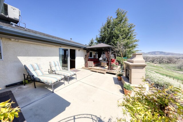 22824 Mariposa Rd, Tehachapi, CA 93561 - view of patio / terrace with cooling unit, a gazebo, and a mountain view