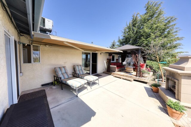22824 Mariposa Rd, Tehachapi, CA 93561 - view of patio / terrace with an outdoor fireplace and central AC