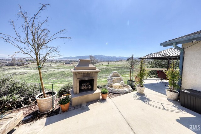 22824 Mariposa Rd, Tehachapi, CA 93561 - view of patio featuring a tiled fireplace, a mountain view, and a gazebo
