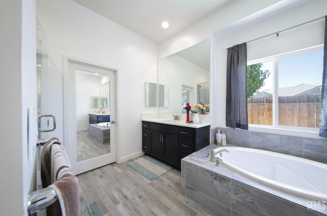 15920 Waterford St, Bakersfield, CA 93314 - full bath with vanity, a bath, wood finished floors, and lofted ceiling