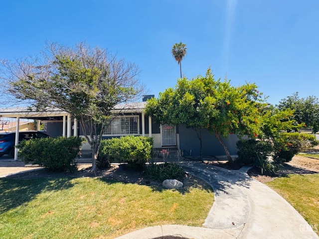 obstructed view of property featuring a front lawn