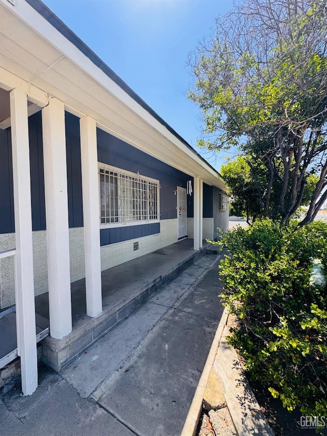 view of home's exterior featuring a porch and crawl space
