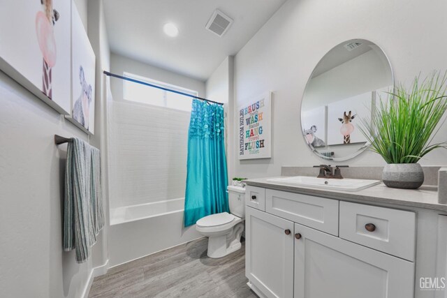 7518 Garrison Ave, Bakersfield, CA 93311 - bathroom featuring toilet, wood finished floors, vanity, and shower / bath combination with curtain