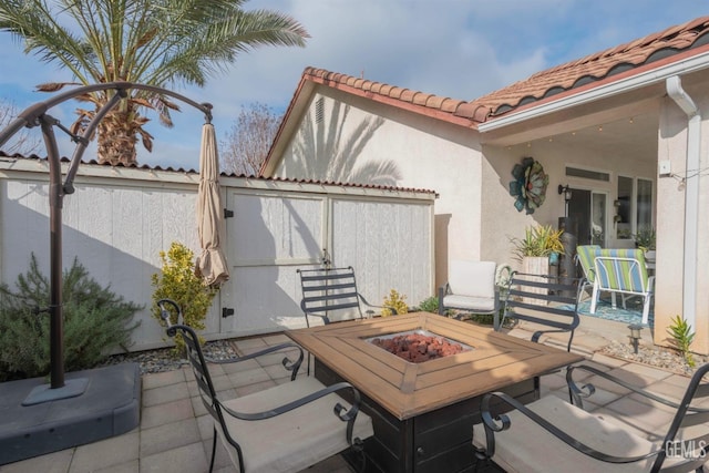 view of patio with an outdoor fire pit