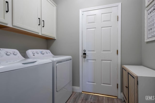 washroom featuring cabinets, dark wood-type flooring, and independent washer and dryer