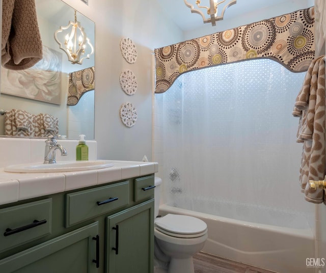 full bathroom with vanity, shower / tub combo, a chandelier, and toilet