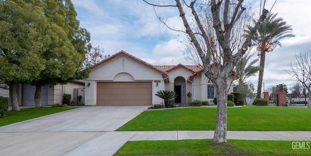 view of front of property featuring a garage and a front lawn