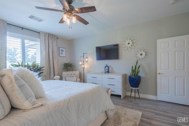 bedroom with hardwood / wood-style floors and ceiling fan