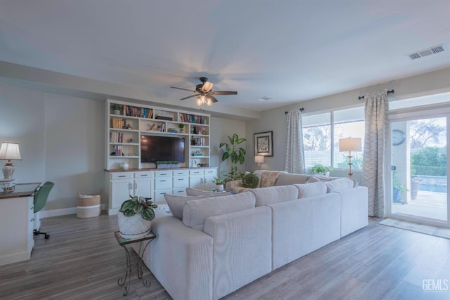 living room featuring hardwood / wood-style flooring and ceiling fan