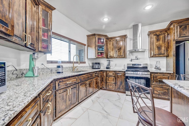 28124 Mustang Ave, Taft, CA 93268 - kitchen featuring wall chimney range hood, stainless steel appliances, a sink, light marble finish floors, and light stone countertops