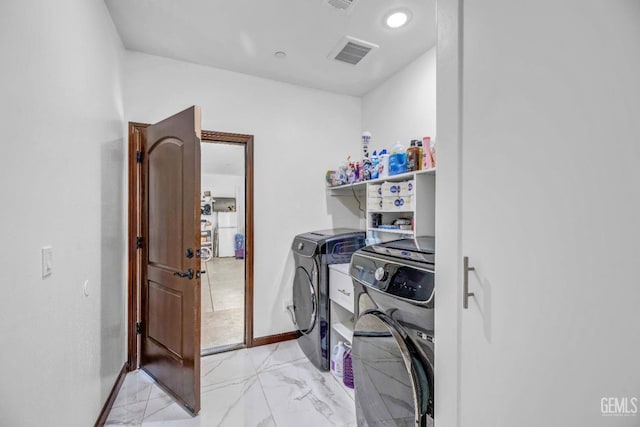 28124 Mustang Ave, Taft, CA 93268 - clothes washing area featuring washing machine and dryer, light marble finish floors, and baseboards