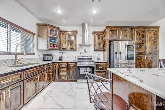28124 Mustang Ave, Taft, CA 93268 - kitchen with appliances with stainless steel finishes, a sink, wall chimney exhaust hood, light marble finish flooring, and light stone countertops