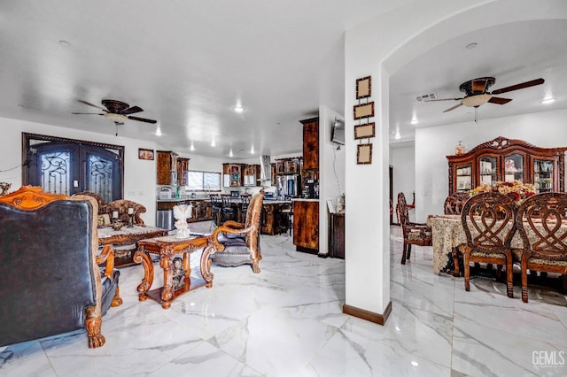 28124 Mustang Ave, Taft, CA 93268 - living room featuring ceiling fan, light marble finish flooring, and arched walkways