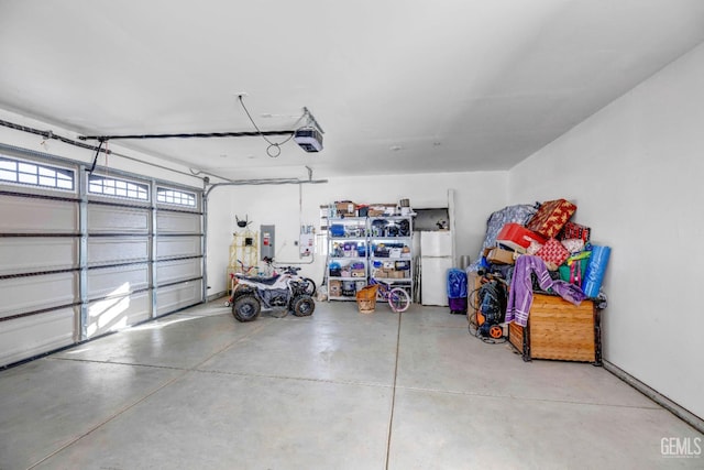28124 Mustang Ave, Taft, CA 93268 - garage featuring a garage door opener and freestanding refrigerator
