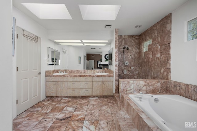 bathroom featuring a skylight, a garden tub, double vanity, visible vents, and a walk in shower