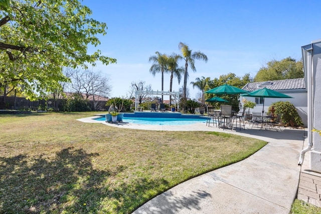 view of swimming pool with a patio area, a fenced in pool, a pergola, and a yard