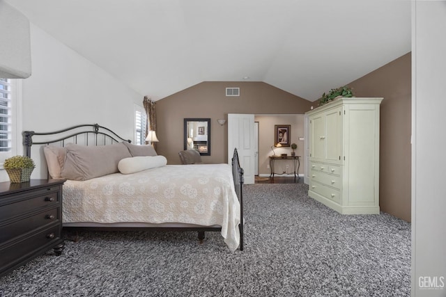 bedroom with lofted ceiling, visible vents, and carpet flooring