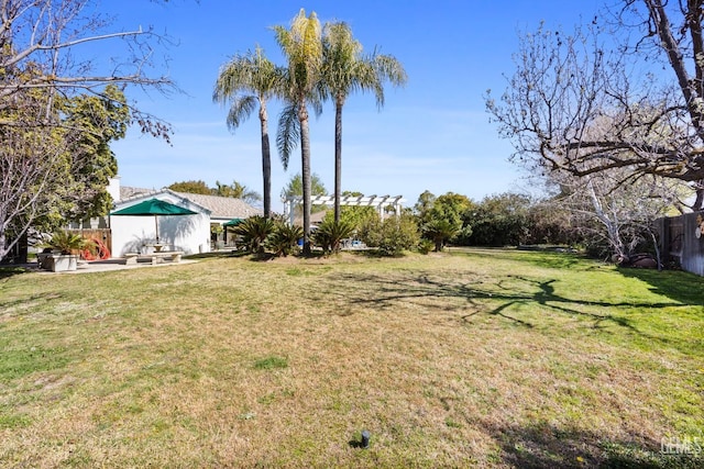 view of yard featuring fence, a pergola, and a patio