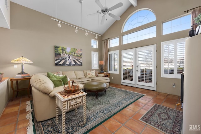 tiled living room featuring high vaulted ceiling, french doors, track lighting, and a ceiling fan