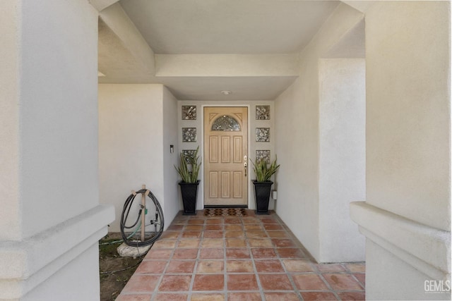 entrance to property with stucco siding