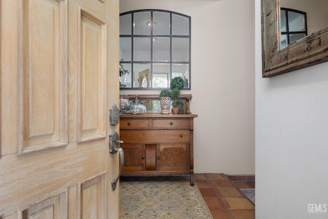 doorway to outside with tile patterned floors