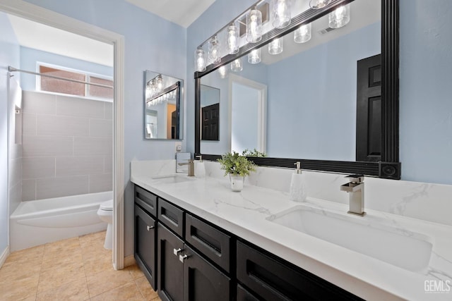 full bath featuring tile patterned floors, a sink, toilet, and double vanity