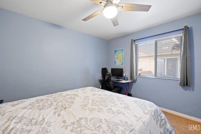 carpeted bedroom with ceiling fan and baseboards