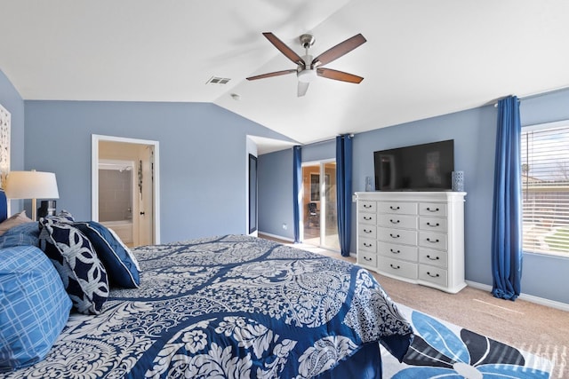 carpeted bedroom featuring visible vents, vaulted ceiling, ceiling fan, ensuite bath, and baseboards