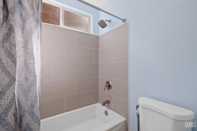 bathroom featuring shower / bath combo with shower curtain and toilet