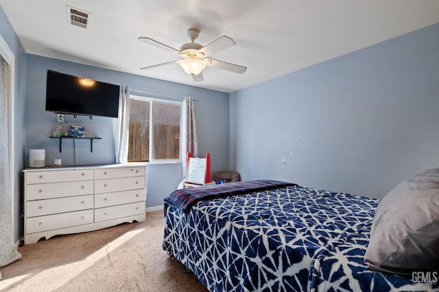 carpeted bedroom featuring ceiling fan and visible vents