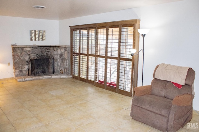 living area featuring a fireplace and visible vents