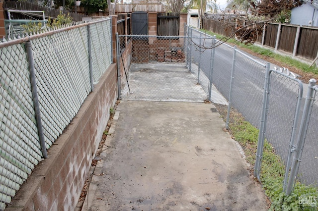 view of gate with a fenced backyard