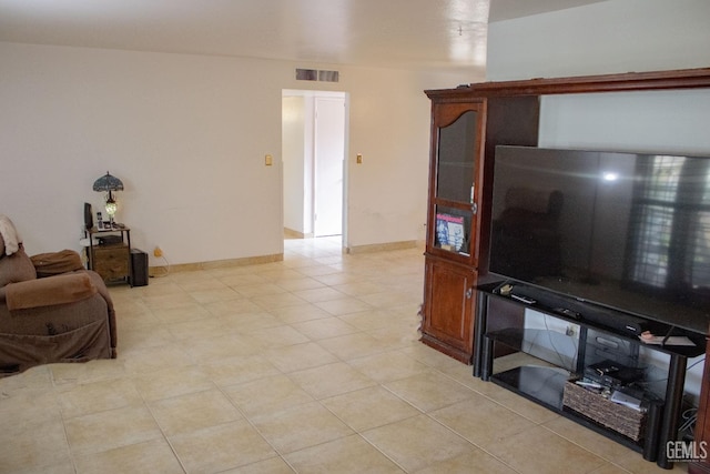 living room with baseboards and visible vents