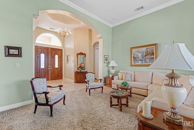 living room featuring arched walkways, a chandelier, visible vents, and crown molding