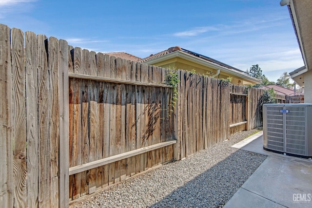 view of yard with fence and central AC