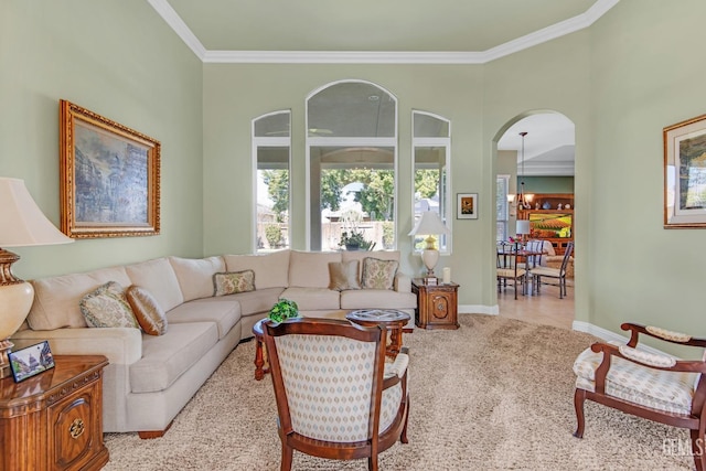 living room with ornamental molding, arched walkways, baseboards, and tile patterned floors