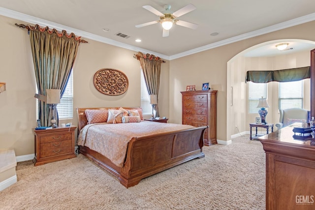 bedroom with light colored carpet, arched walkways, visible vents, and crown molding