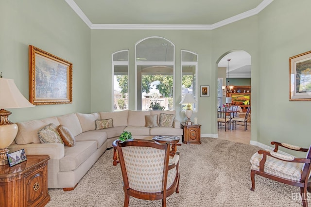 tiled living room featuring ornamental molding, carpet, arched walkways, and baseboards