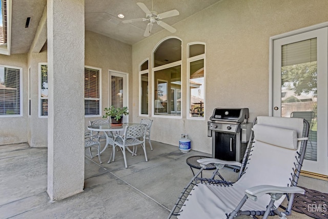 view of patio / terrace with grilling area, a ceiling fan, and outdoor dining space