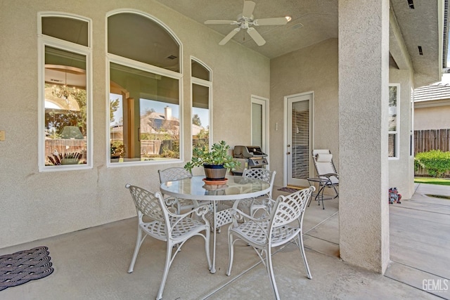 view of patio featuring a ceiling fan, outdoor dining space, and grilling area