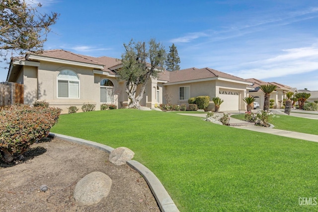 mediterranean / spanish-style home featuring a tile roof, stucco siding, a front yard, a garage, and driveway