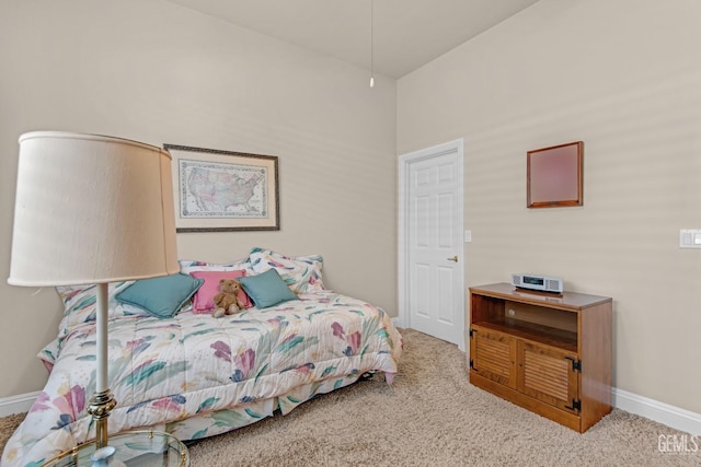 carpeted bedroom featuring baseboards