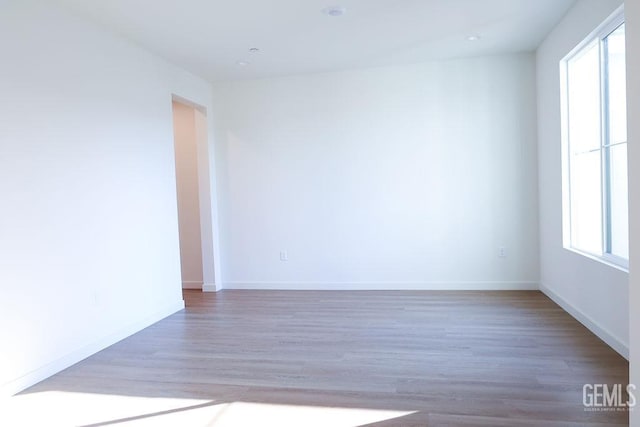 spare room with dark hardwood / wood-style floors