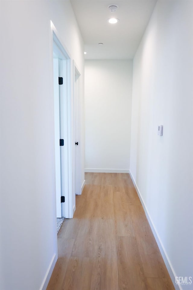 corridor with light hardwood / wood-style flooring