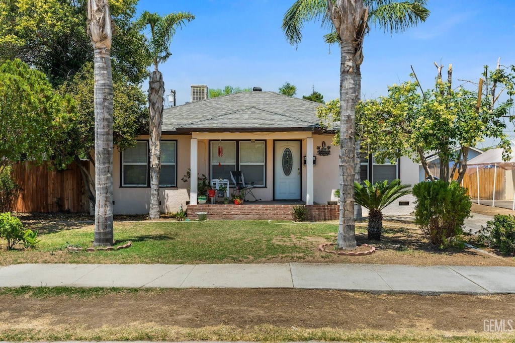 1622 6th St, Wasco, CA 93280 - bungalow-style home featuring stucco siding, covered porch, and roof with shingles