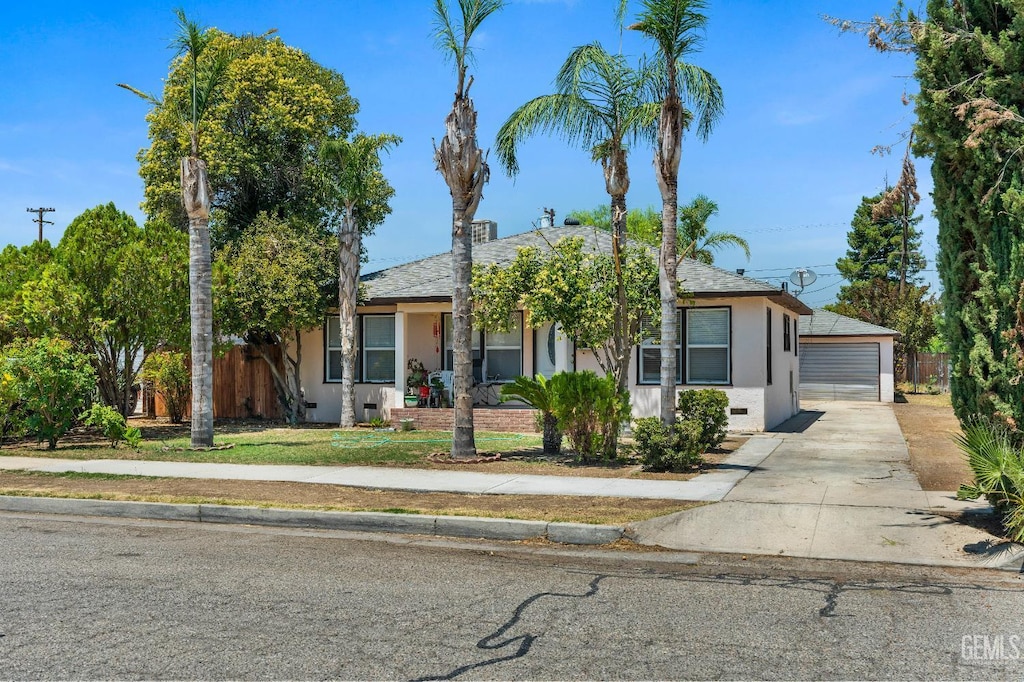1622 6th St, Wasco, CA 93280 - view of property hidden behind natural elements featuring stucco siding, a detached garage, an outbuilding, and crawl space