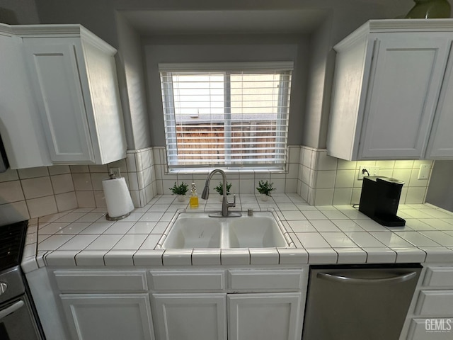2114 Via Lazio Ave, Delano, CA 93215 - kitchen featuring a sink, stainless steel dishwasher, white cabinets, and decorative backsplash